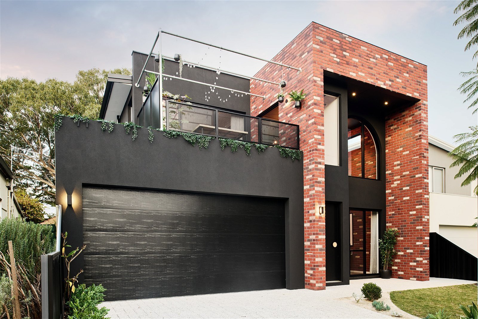 Street view of a two-storey home designed for a Perth residential lot consisting of industrial architectural style and brickwork finish.